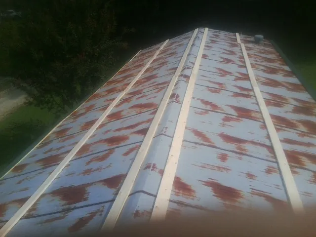 Rusted metal roof panels with new wood purlins before replacement — Storm Damage Roof Repair in Cornelius by Roofing Brothers